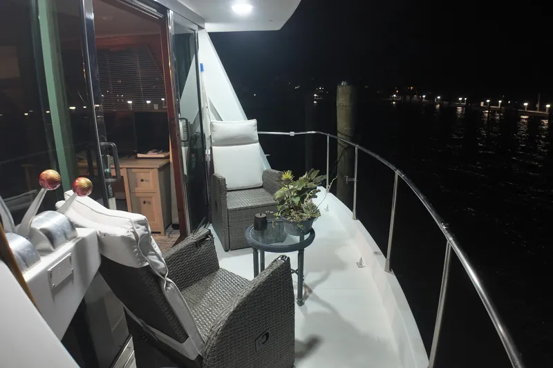  Yacht Photos Pics 1987 Viking Gulfstar yacht deck at night with chairs and table.