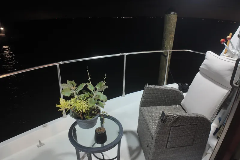  Yacht Photos Pics Cozy deck of 1987 Viking Gulfstar yacht with chair and potted plant at night.
