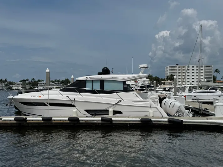 19th Hole Yacht Photos Pics 2024 Regal 38 XO yacht docked at marina under cloudy sky.