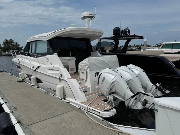 19th Hole Yacht Photos Pics 2024 Regal 38 XO yacht docked with twin outboard engines, sleek design.