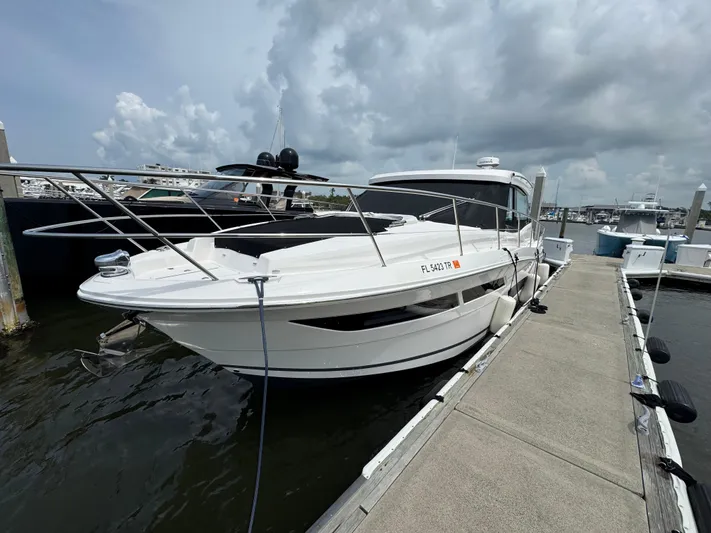 19th Hole Yacht Photos Pics 2024 Regal 38 XO boat docked at marina under cloudy sky.