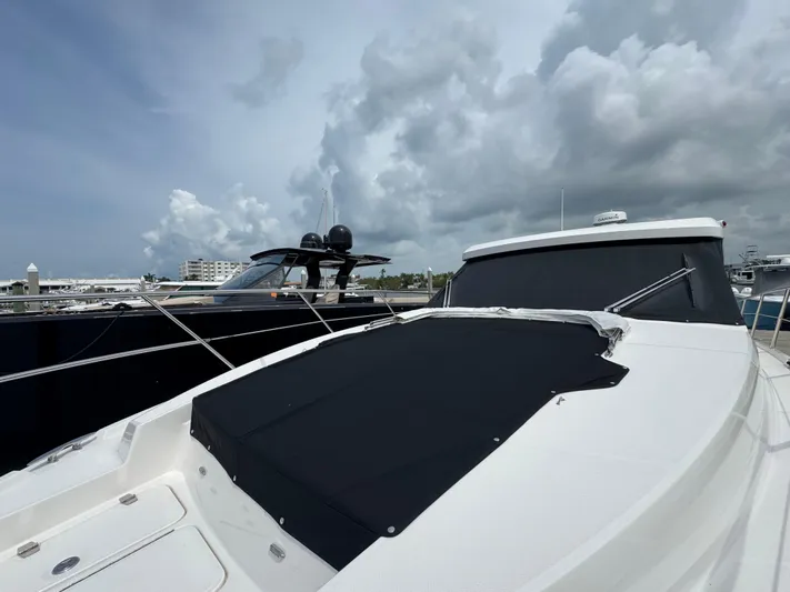 19th Hole Yacht Photos Pics 2024 Regal 38 XO yacht docked under cloudy skies.