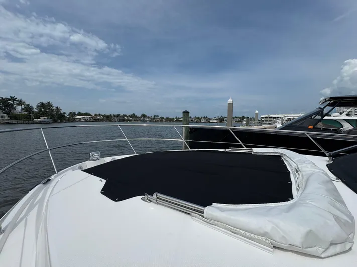 19th Hole Yacht Photos Pics 2024 Regal 38 XO yacht docked by a scenic waterfront.