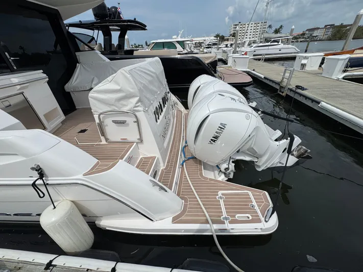 19th Hole Yacht Photos Pics 2024 Regal 38 XO yacht with Yamaha outboard engines docked at a marina.