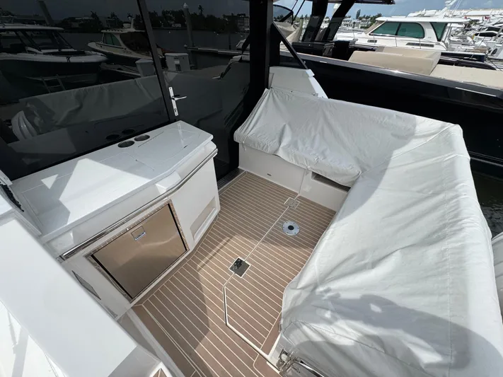 19th Hole Yacht Photos Pics 2024 Regal 38 XO yacht interior with covered seating and sleek design.