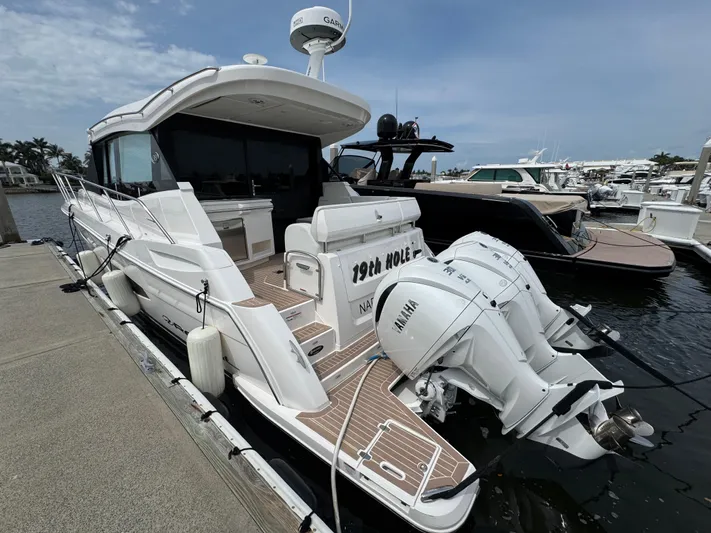 19th Hole Yacht Photos Pics 2024 Regal 38 XO yacht docked, featuring twin Yamaha outboard engines and sleek design.