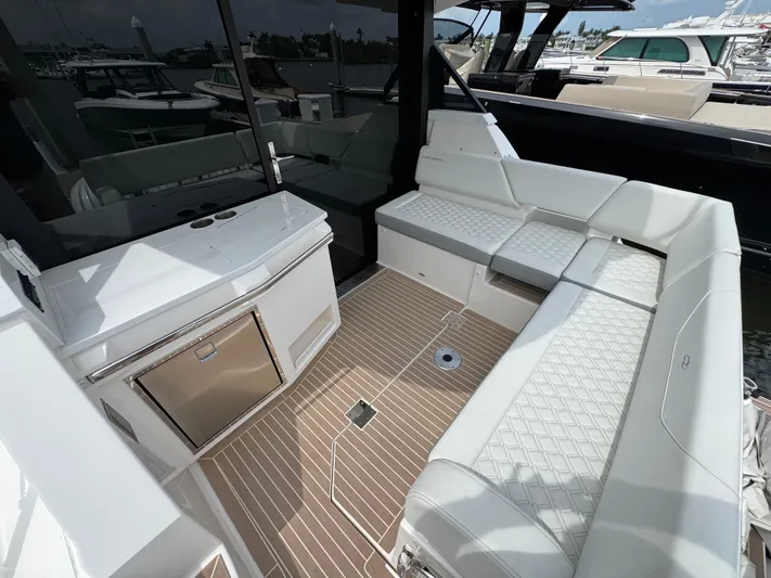 19th Hole Yacht Photos Pics 2024 Regal 38 XO yacht interior with white seating and sleek design.