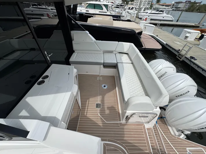 19th Hole Yacht Photos Pics 2024 Regal 38 XO yacht deck with seating and Yamaha engines at marina.