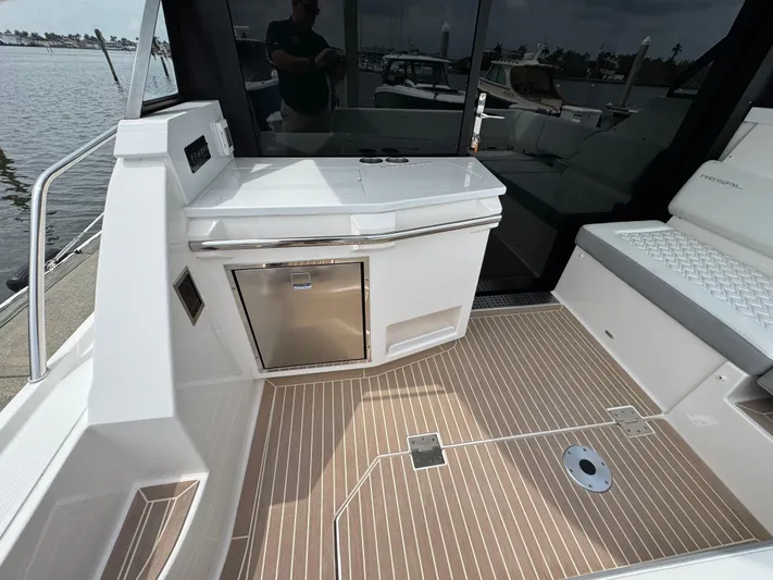 19th Hole Yacht Photos Pics 2024 Regal 38 XO yacht deck with kitchenette and seating area.