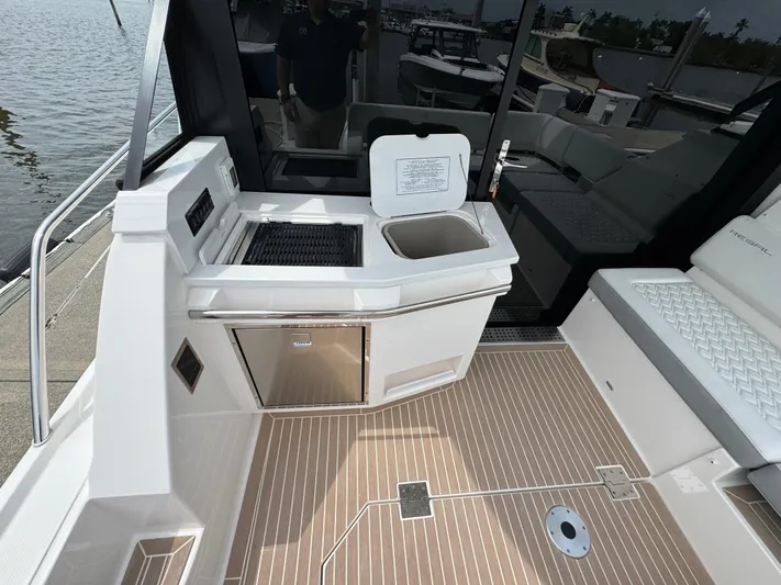 19th Hole Yacht Photos Pics 2024 Regal 38 XO yacht kitchenette with sink and grill on deck.