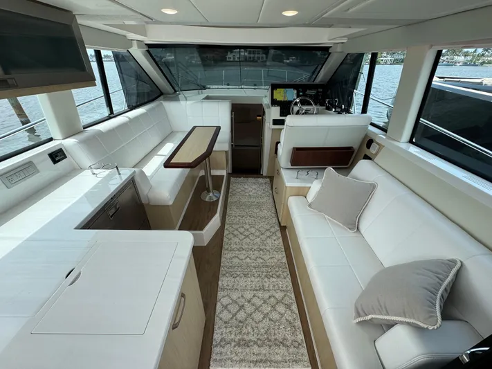 19th Hole Yacht Photos Pics Luxurious interior of 2024 Regal 38 XO yacht with modern seating and helm.