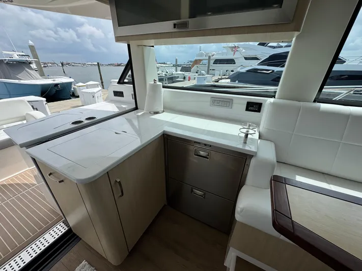 19th Hole Yacht Photos Pics 2024 Regal 38 XO yacht interior with modern kitchen and marina view.