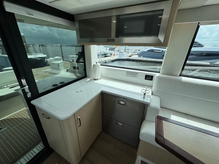 19th Hole Yacht Photos Pics 2024 Regal 38 XO yacht interior with modern kitchen and seating area.