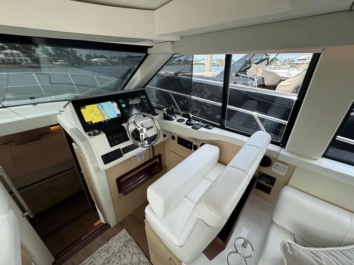 19th Hole Yacht Photos Pics 2024 Regal 38 XO yacht cockpit with modern navigation system and luxurious seating.