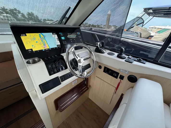 19th Hole Yacht Photos Pics 2024 Regal 38 XO yacht helm with navigation display and steering wheel.