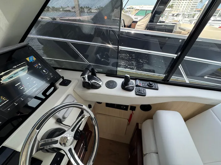 19th Hole Yacht Photos Pics 2024 Regal 38 XO yacht helm with modern controls and navigation display.