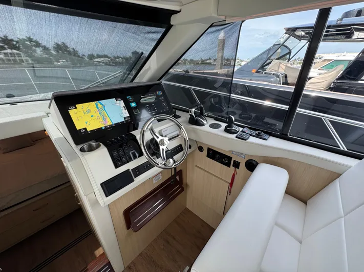 19th Hole Yacht Photos Pics 2024 Regal 38 XO yacht cockpit with modern navigation system and luxurious seating.