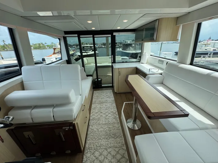 19th Hole Yacht Photos Pics Luxurious interior of 2024 Regal 38 XO yacht with white seating and modern design.