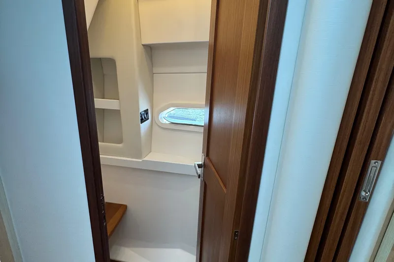 19th Hole Yacht Photos Pics 2024 Regal 38 XO yacht interior with wooden door and window.