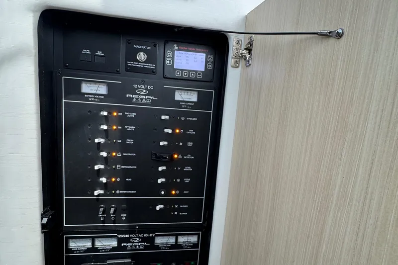 19th Hole Yacht Photos Pics Electrical control panel of 2024 Regal 38 XO boat with switches and indicators.