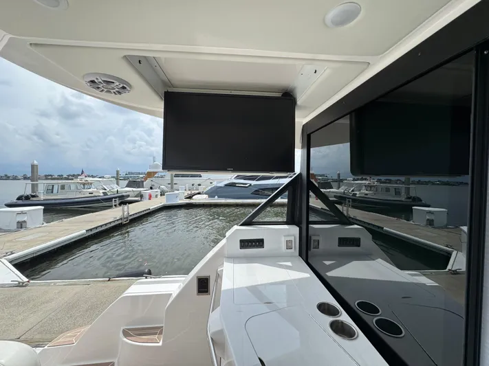 19th Hole Yacht Photos Pics 2024 Regal 38 XO yacht interior with marina view, featuring sleek design and modern amenities.