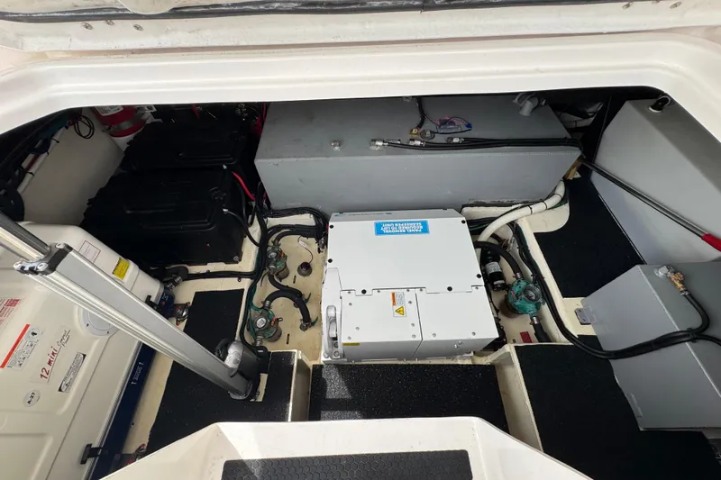 19th Hole Yacht Photos Pics Engine compartment of 2024 Regal 38 XO boat, showcasing mechanical components and wiring.