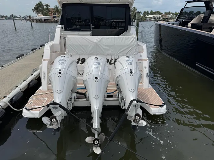 19th Hole Yacht Photos Pics 2024 Regal 38 XO yacht with triple outboard engines docked at marina.