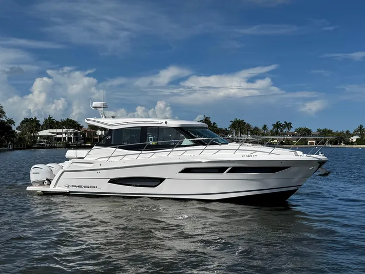 19th Hole Yacht Photos Pics 2024 Regal 38 XO yacht cruising on a sunny day with a clear blue sky.