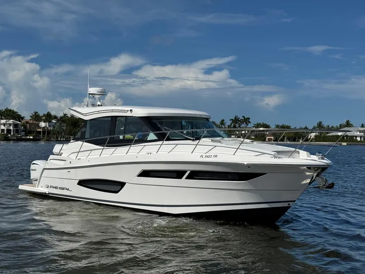 19th Hole Yacht Photos Pics 2024 Regal 38 XO yacht cruising on a sunny day, showcasing sleek design and luxury features.