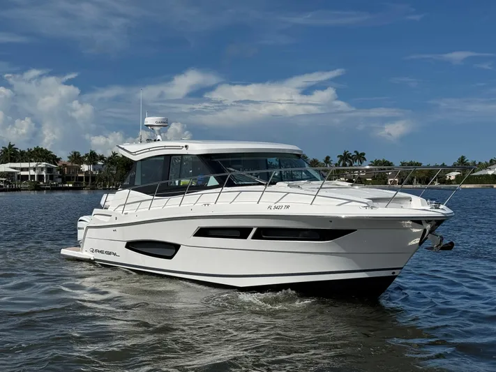 19th Hole Yacht Photos Pics 2024 Regal 38 XO yacht cruising on a sunny day, with a sleek white design.