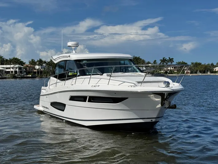 19th Hole Yacht Photos Pics 2024 Regal 38 XO yacht cruising on a sunny day, calm waters, blue sky.