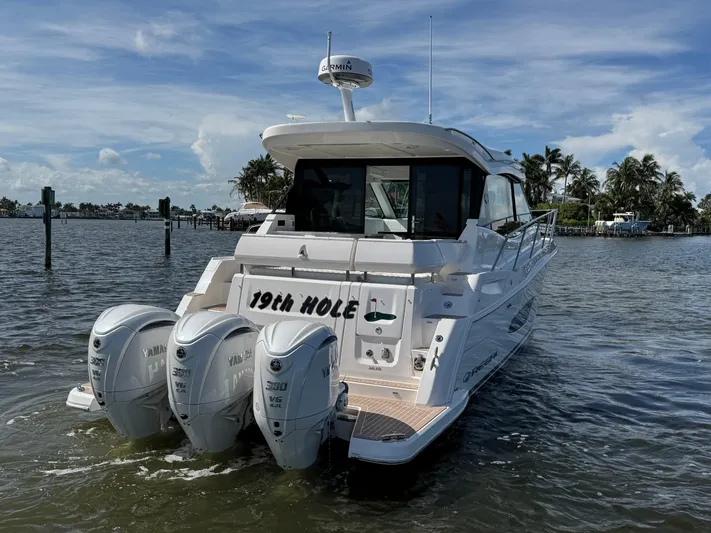 19th Hole Yacht Photos Pics 2024 Regal 38 XO boat with triple Yamaha engines on a sunny day.