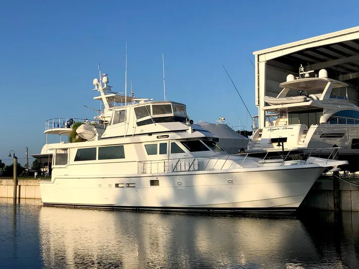 Sunset Grille Yacht Photos Pics 1990 Hatteras 62 Cockpit Motor Yacht docked at marina under clear sky.