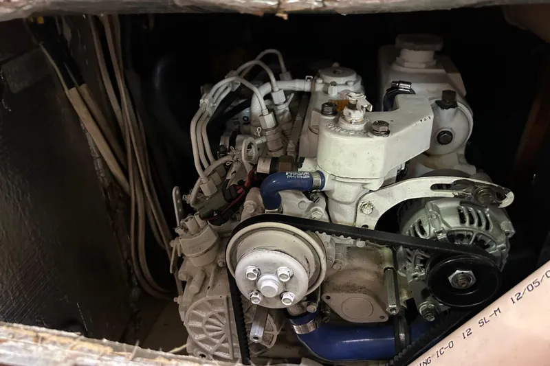 Zephyrus Yacht Photos Pics Engine compartment of a 1991 Beneteau 500 Oceanis sailboat, showcasing mechanical components.