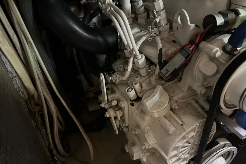 Zephyrus Yacht Photos Pics Engine compartment of a 1991 Beneteau 500 Oceanis sailboat, showing mechanical components.