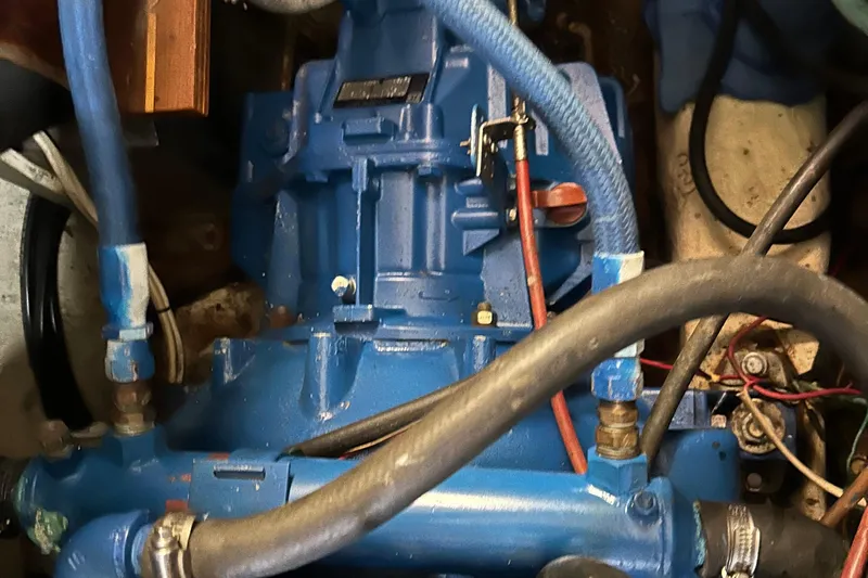 Zephyrus Yacht Photos Pics Engine compartment of a 1991 Beneteau 500 Oceanis sailboat, featuring blue mechanical components.