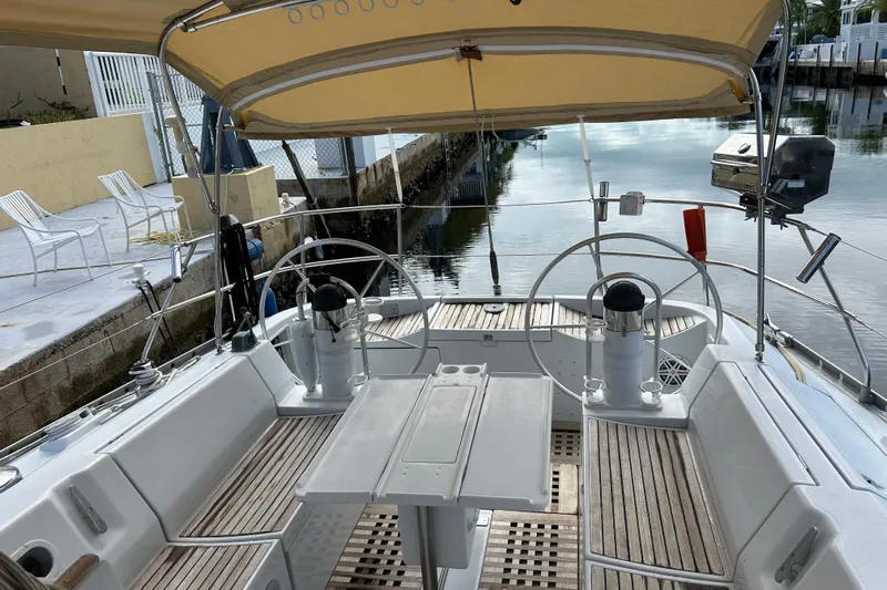 Zephyrus Yacht Photos Pics Cockpit of 1991 Beneteau 500 Oceanis sailboat with dual steering wheels and teak flooring.