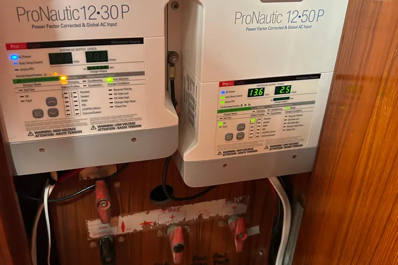 Zephyrus Yacht Photos Pics ProNautic chargers in a 1991 Beneteau 500 Oceanis, displaying voltage and amperage readings.