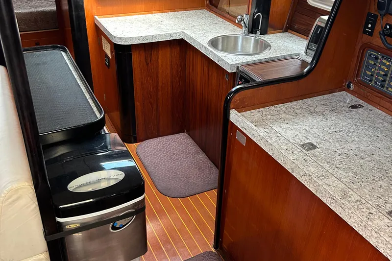 Zephyrus Yacht Photos Pics Interior of 1991 Beneteau 500 Oceanis yacht with wood and granite finishes.