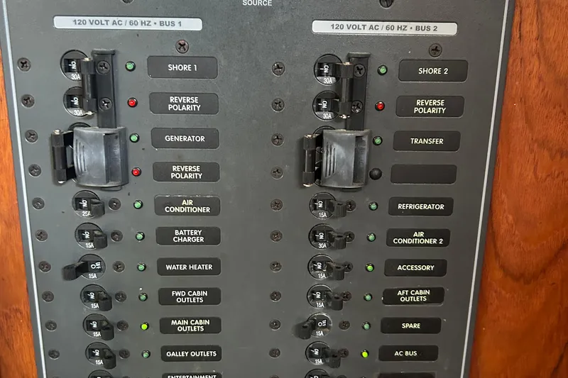 Zephyrus Yacht Photos Pics Electrical panel of a 1991 Beneteau 500 Oceanis sailboat, showing circuit breakers and switches.