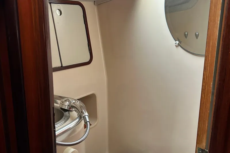 Zephyrus Yacht Photos Pics Bathroom interior of 1991 Beneteau 500 Oceanis yacht with sink and mirror.