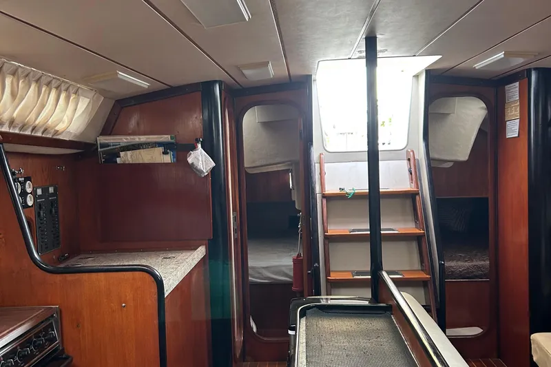 Zephyrus Yacht Photos Pics Interior of 1991 Beneteau 500 Oceanis sailboat, featuring wood paneling and compact design.