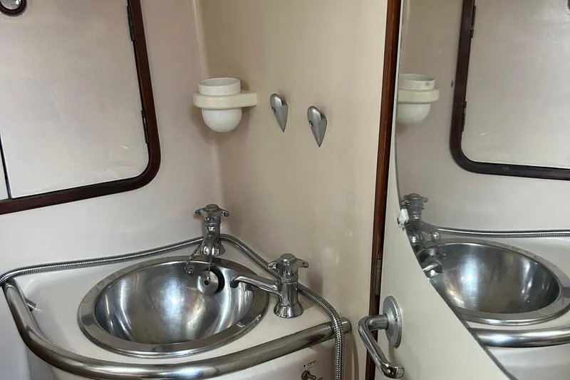 Zephyrus Yacht Photos Pics Stainless steel sink in 1991 Beneteau 500 Oceanis yacht bathroom.