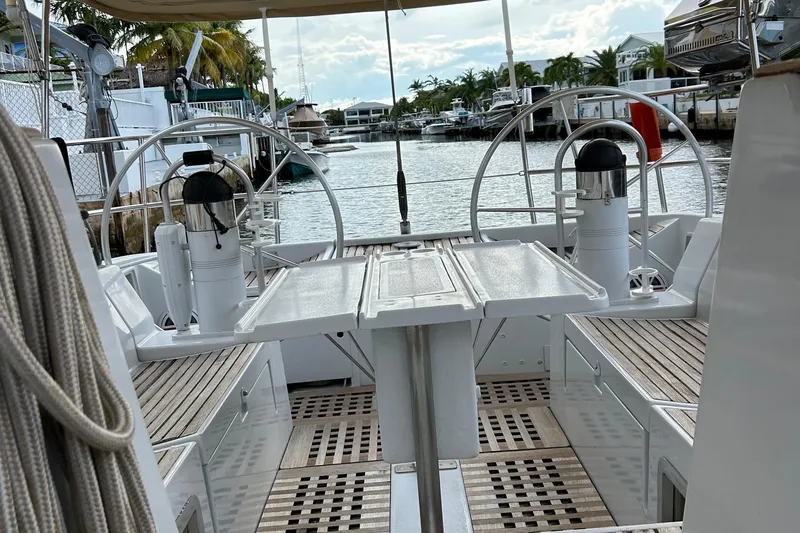 Zephyrus Yacht Photos Pics Cockpit view of 1991 Beneteau 500 Oceanis sailboat, featuring dual steering wheels and teak decking.