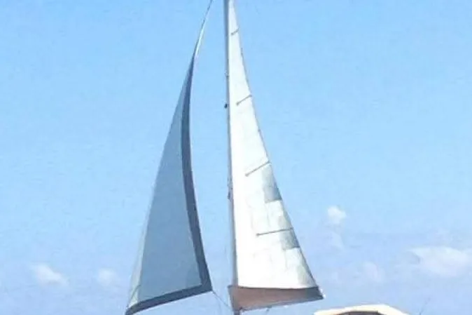 Zephyrus Yacht Photos Pics Sailing yacht Beneteau 500 Oceanis 1991 with full sails against blue sky.