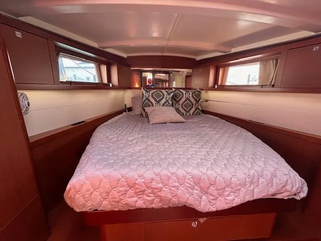 Laguna D Yacht Photos Pics Luxurious bedroom interior of a 2013 Beneteau 48 yacht with a cozy bed.
