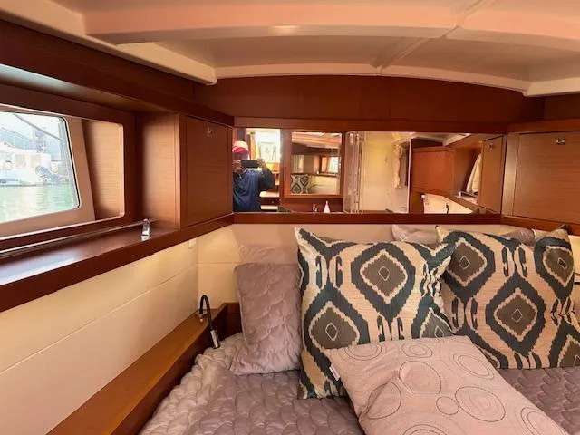 Laguna D Yacht Photos Pics Interior cabin of 2013 Beneteau 48 yacht with cozy bedding and decorative pillows.