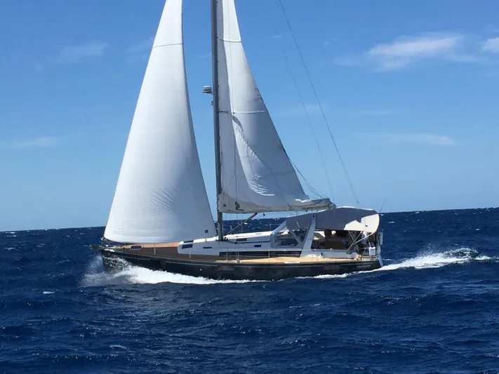 Laguna D Yacht Photos Pics 2013 Beneteau 48 sailboat cruising on open ocean under clear blue sky.