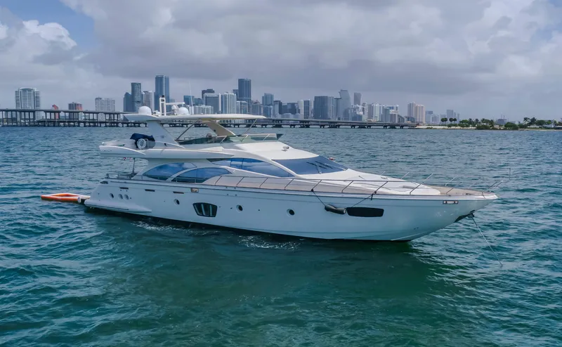 Thinks It's His Too Yacht Photos Pics 2008 Azimut Flybridge yacht on water with city skyline in background.