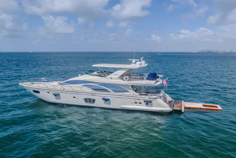 Thinks It's His Too Yacht Photos Pics 2008 Azimut Flybridge yacht cruising on open sea under blue sky.